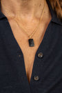 close up of woman wearing Difficult Woman engraved in Teeline Shorthand on an Onyx Gemstone Pendant and hanging on a on twisted gold vermeil necklace  and matching Difficult Woman gold coin hoop earrings 