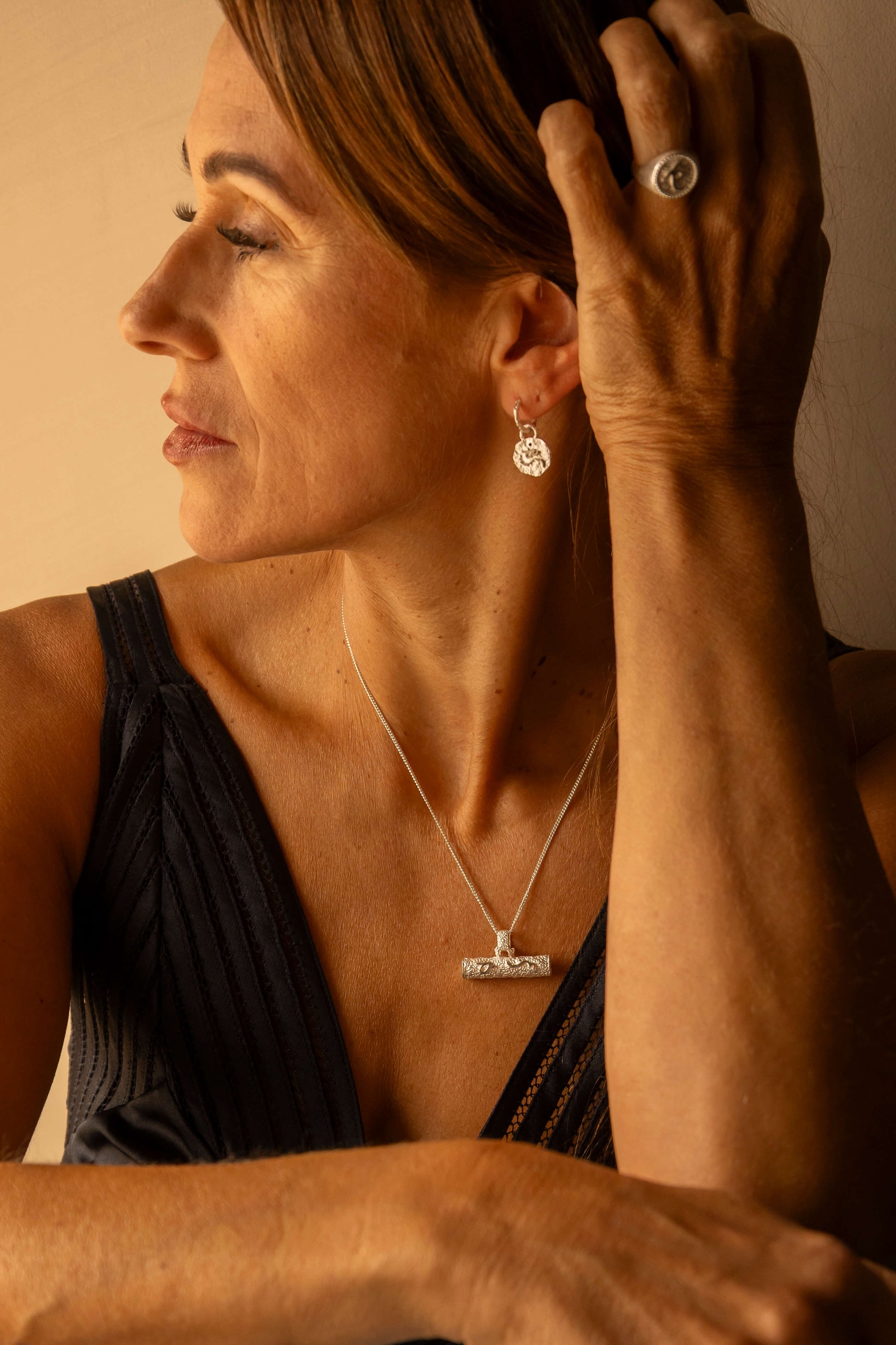 model wears Difficult Woman Silver Huggie Hoops