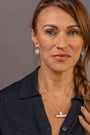 model wears Difficult Woman Silver Huggie Hoops