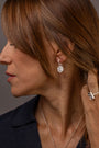 model wears Know Your Worth Silver Huggie Hoops side view 