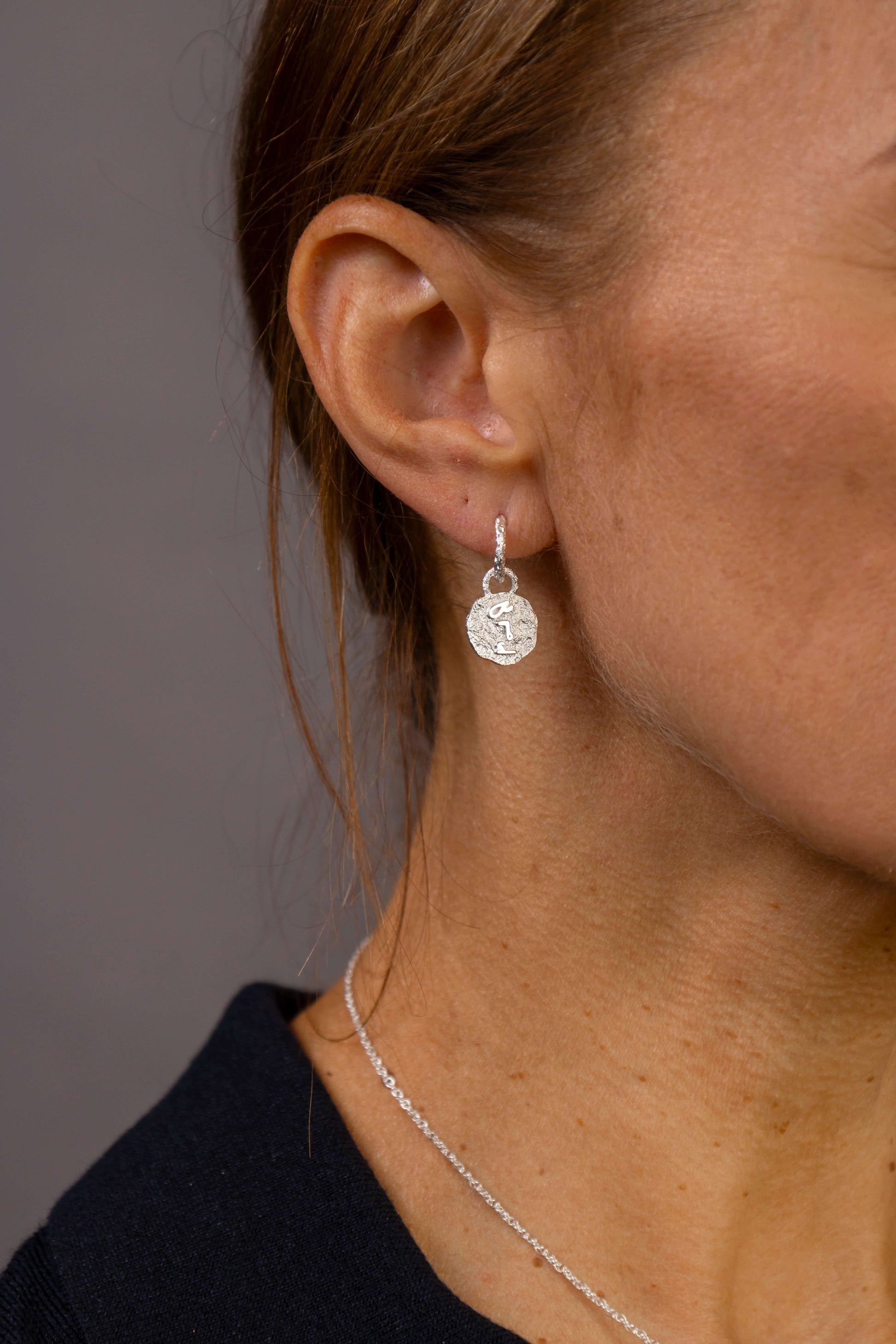 model wears F*** this Sh*t Silver Huggie Hoops