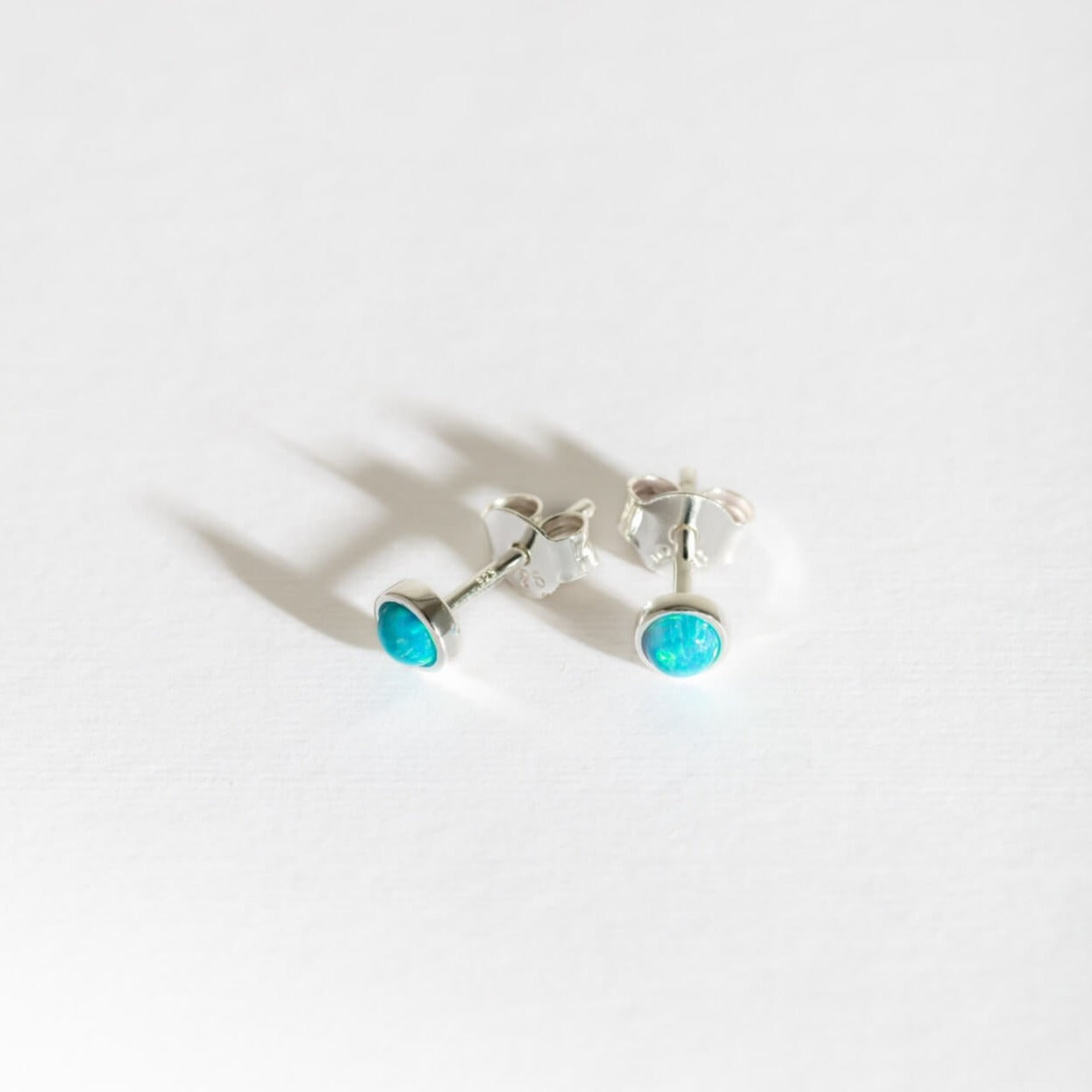 silver and blue lab grown opal stud earrings