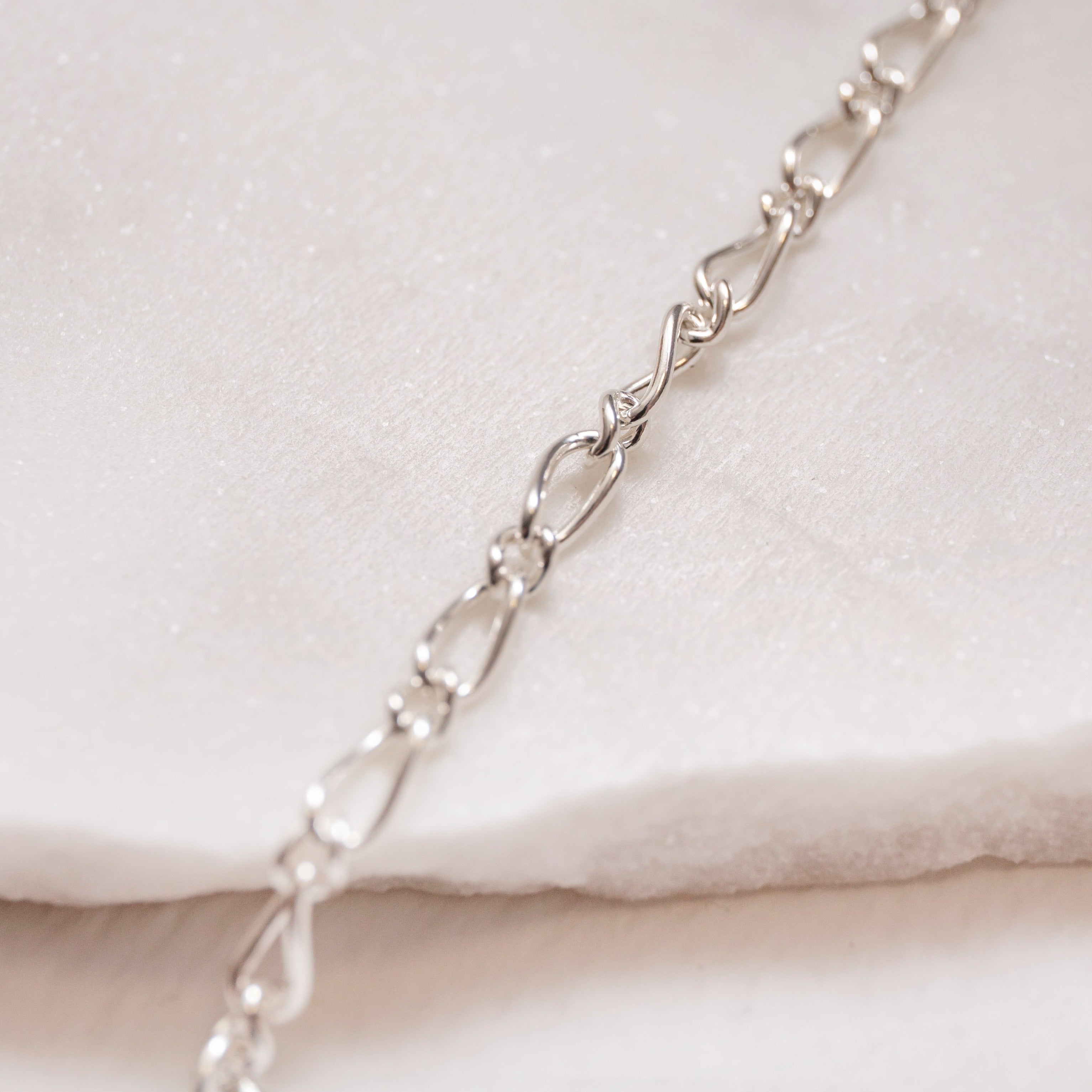 close up of figaro chain necklace silver