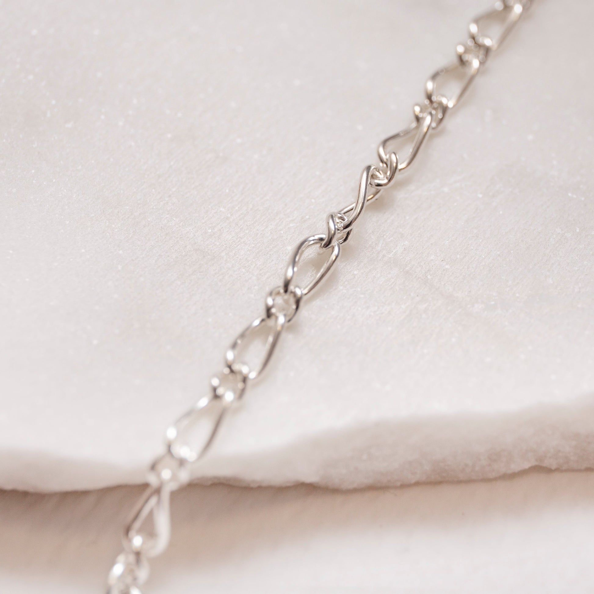 close up of figaro chain necklace silver