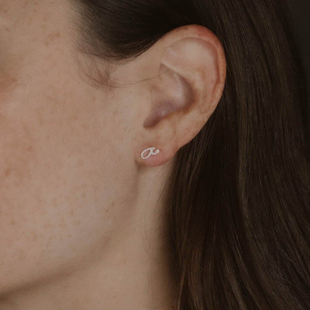 model wears Silver Fuck Shorthand Stud earring 