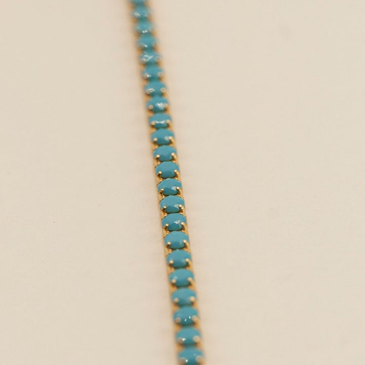Close up of turquoise and 18k gold vermeil tennis bracelet 
